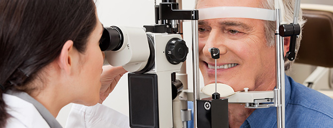 Ophthalmologist examining patient using a scope device